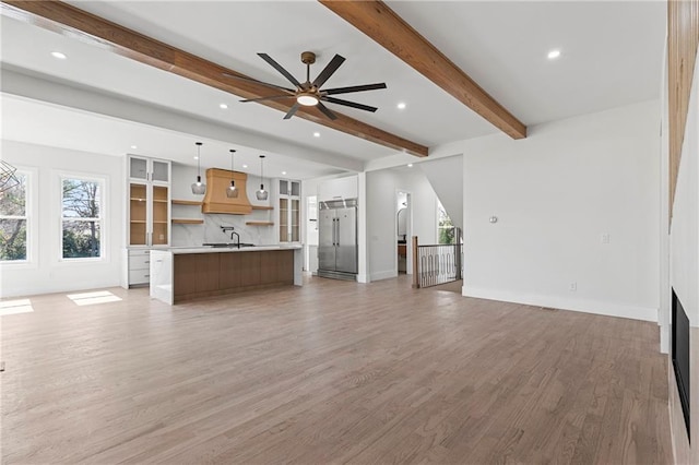 1857 Defoor Ave, Atlanta, GA 30318 - unfurnished living room with a ceiling fan, a sink, beamed ceiling, recessed lighting, and light wood-style flooring