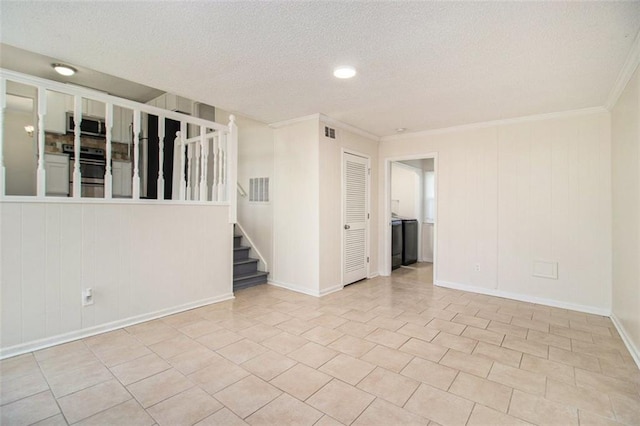 unfurnished room with visible vents, a textured ceiling, crown molding, and stairway