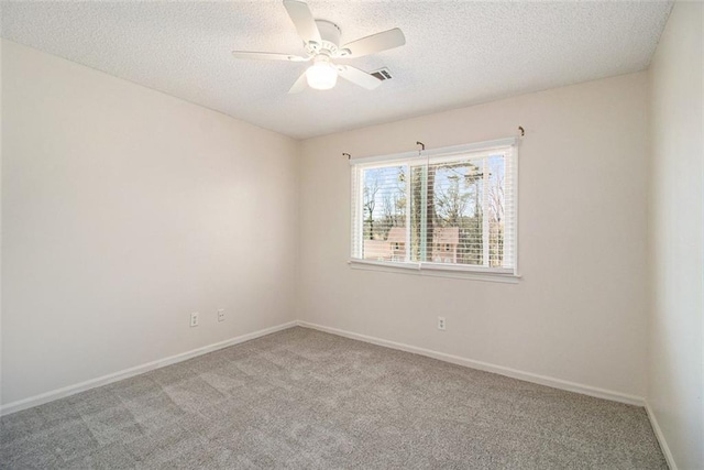 unfurnished room featuring a ceiling fan, baseboards, a textured ceiling, and carpet flooring