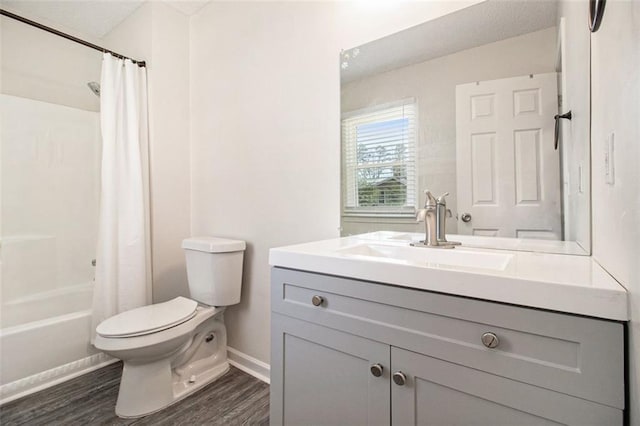 full bath with shower / bath combo with shower curtain, toilet, wood finished floors, baseboards, and vanity