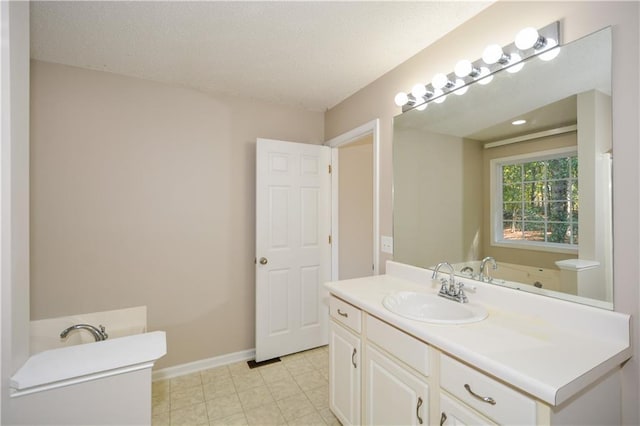 bathroom featuring vanity and a textured ceiling