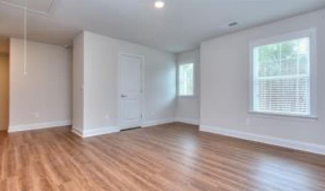 unfurnished room with light wood-style floors and baseboards