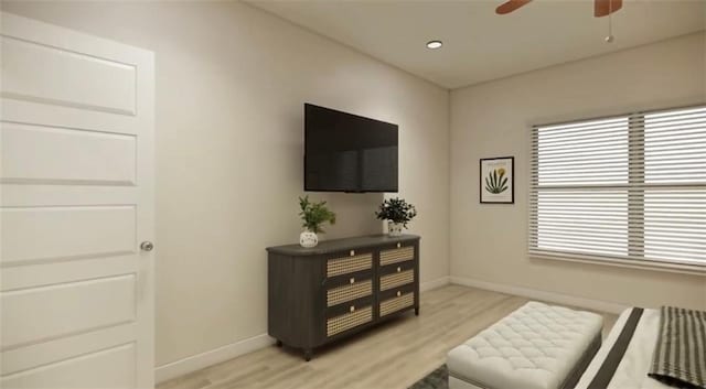 sitting room with ceiling fan, light wood finished floors, and baseboards