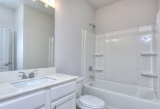 bathroom featuring toilet, bathtub / shower combination, and vanity