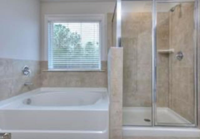 bathroom with a garden tub and a shower stall