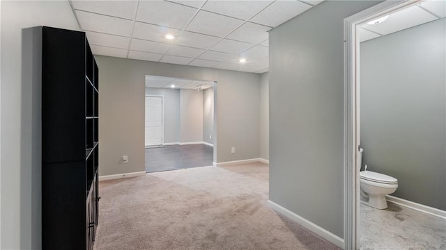 carpeted empty room featuring a paneled ceiling