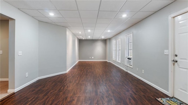 interior space featuring dark hardwood / wood-style flooring and a drop ceiling