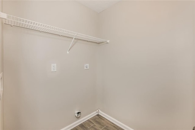 clothes washing area featuring hookup for an electric dryer and hardwood / wood-style flooring