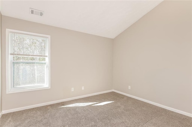 empty room featuring carpet floors, a wealth of natural light, and lofted ceiling