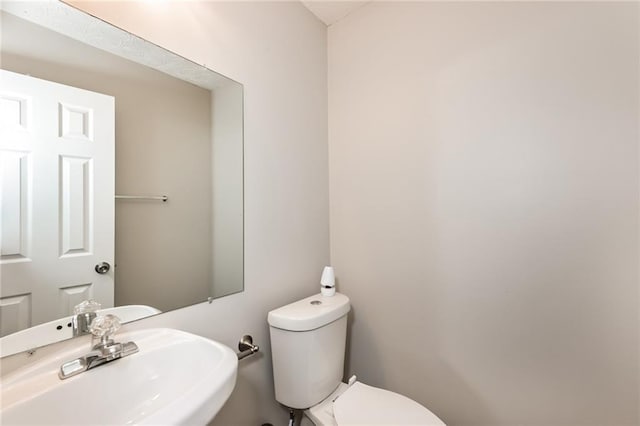 bathroom featuring toilet and sink