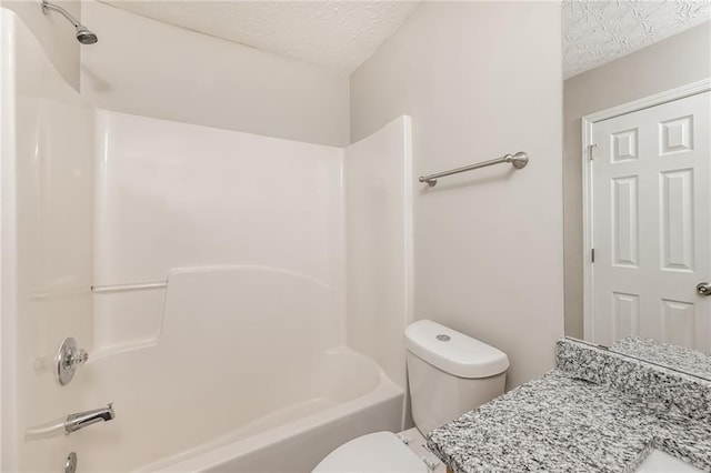 full bathroom with bathtub / shower combination, vanity, a textured ceiling, and toilet