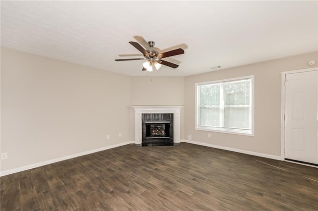 unfurnished living room with ceiling fan, a fireplace, and dark hardwood / wood-style floors