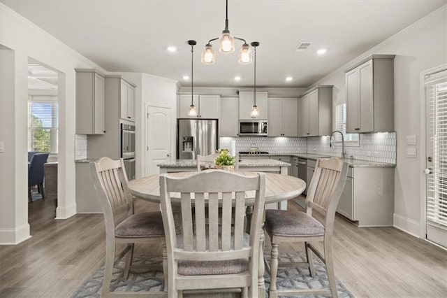 372 Garnet Dr, Acworth, GA 30101 - dining area featuring healthy amount of natural light, light wood-type flooring, baseboards, crown molding, and recessed lighting