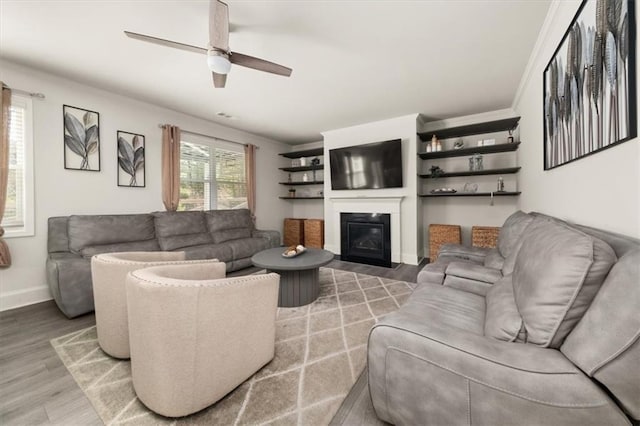 372 Garnet Dr, Acworth, GA 30101 - living area with light wood-style floors, a glass covered fireplace, a ceiling fan, and baseboards