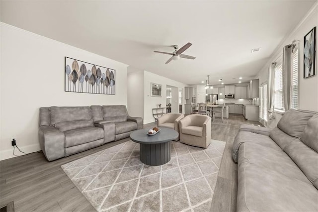 372 Garnet Dr, Acworth, GA 30101 - living room with light wood finished floors, ceiling fan, and baseboards