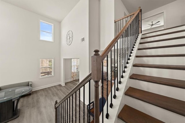 372 Garnet Dr, Acworth, GA 30101 - stairs with wood finished floors, baseboards, a towering ceiling, and a ceiling fan