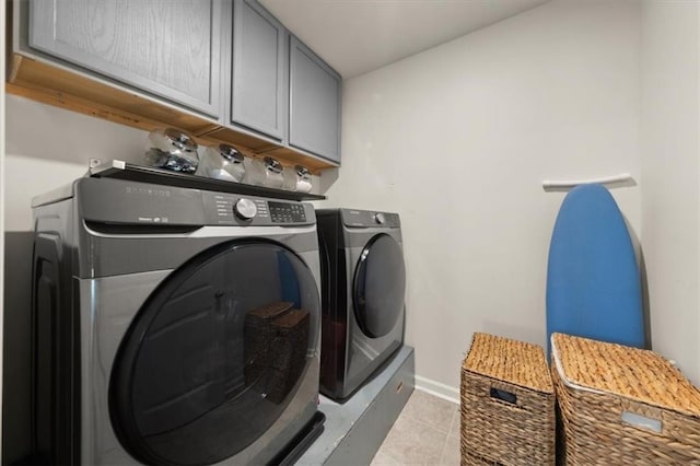 372 Garnet Dr, Acworth, GA 30101 - washroom featuring cabinet space, washing machine and clothes dryer, light tile patterned flooring, and baseboards