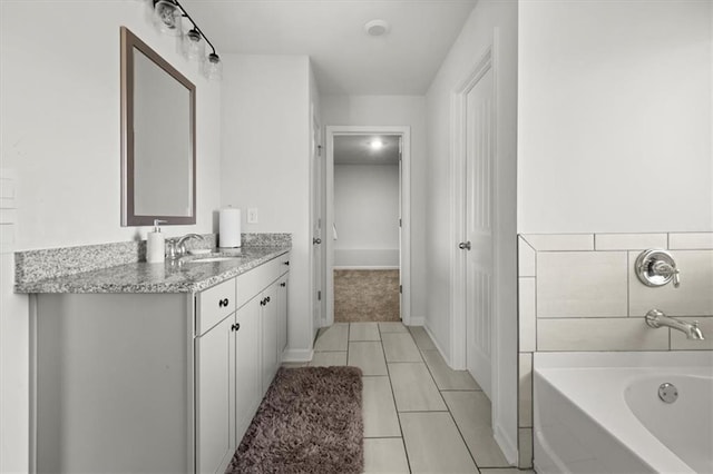 372 Garnet Dr, Acworth, GA 30101 - full bathroom with vanity, a bath, tile patterned floors, and baseboards
