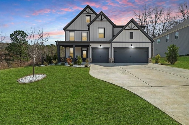 372 Garnet Dr, Acworth, GA 30101 - view of front facade with board and batten siding, driveway, a front lawn, and a garage