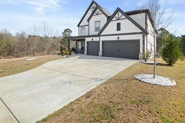 372 Garnet Dr, Acworth, GA 30101 - view of side of home featuring an attached garage, a yard, board and batten siding, and driveway