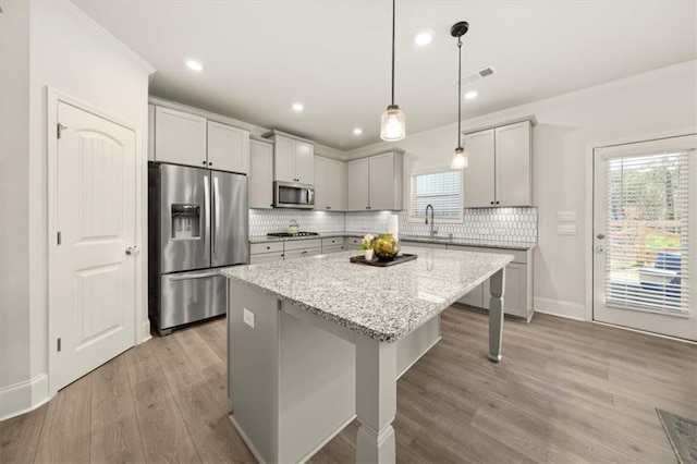 372 Garnet Dr, Acworth, GA 30101 - kitchen with stainless steel appliances, ornamental molding, a sink, a center island, and tasteful backsplash