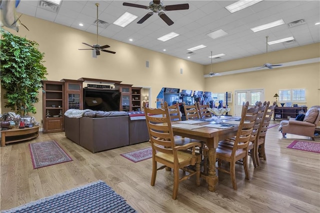 14501 Woolsey Rd, Hampton, GA 30228 - dining space with a ceiling fan, a drop ceiling, light wood-style floors, and a high ceiling