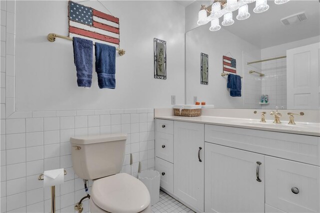 14501 Woolsey Rd, Hampton, GA 30228 - full bathroom featuring vanity, a tile shower, tile walls, wainscoting, and tile patterned floors