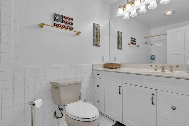 14501 Woolsey Rd, Hampton, GA 30228 - bathroom with vanity, a tile shower, tile walls, a wainscoted wall, and tile patterned floors