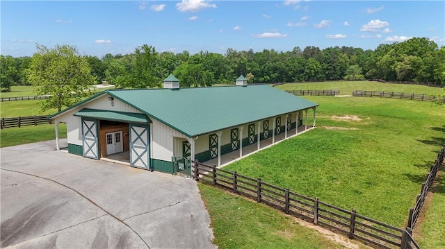 14501 Woolsey Rd, Hampton, GA 30228 - view of front of home featuring asphalt driveway, an exterior structure, a metal roof, and a view of countryside