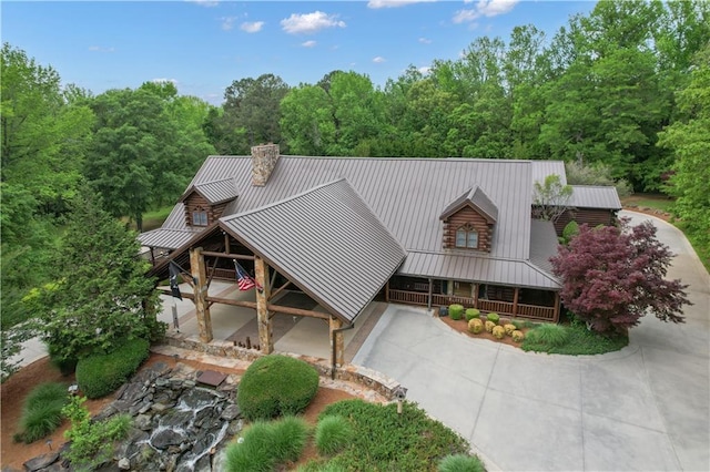 14501 Woolsey Rd, Hampton, GA 30228 - log home featuring driveway, a metal roof, a standing seam roof, covered porch, and a chimney
