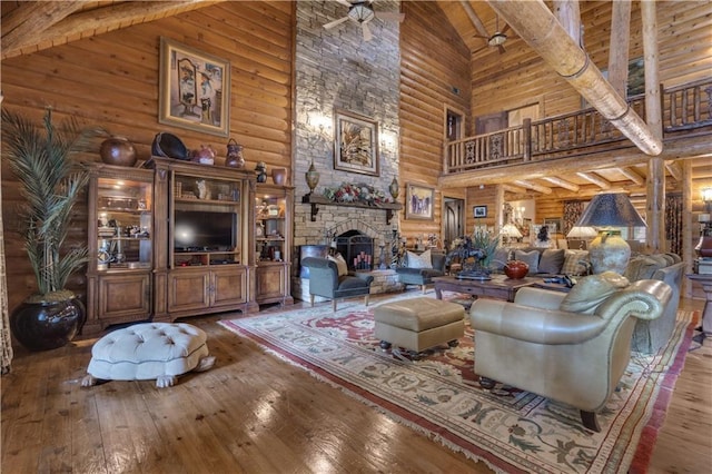 14501 Woolsey Rd, Hampton, GA 30228 - living room with high vaulted ceiling, rustic walls, wood-type flooring, a stone fireplace, and a wood ceiling with exposed beams