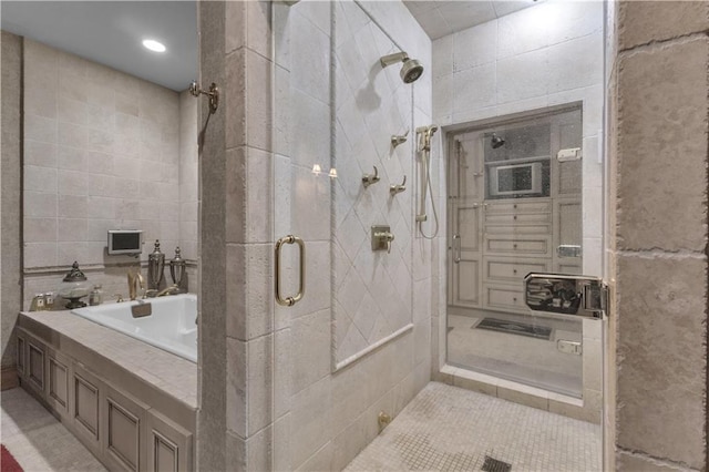 14501 Woolsey Rd, Hampton, GA 30228 - full bathroom with a shower stall, tile walls, and a bath
