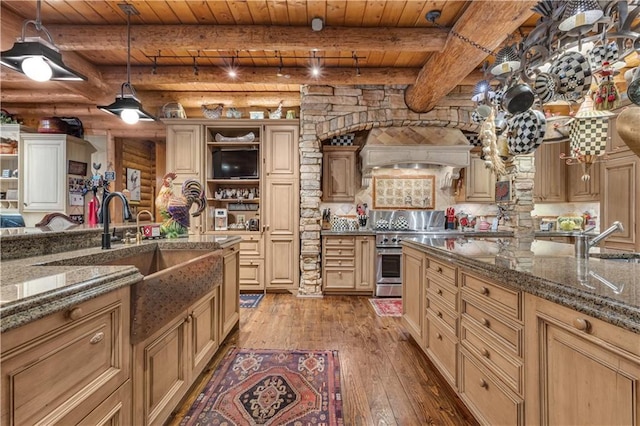 14501 Woolsey Rd, Hampton, GA 30228 - kitchen with wood-type flooring, a wooden ceiling with exposed beams, cream cabinets, pendant lighting, and rustic walls