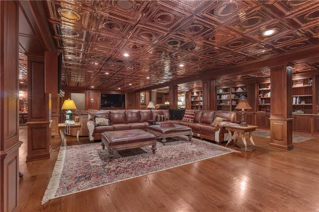 14501 Woolsey Rd, Hampton, GA 30228 - living room with ornate columns, wood finished floors, an ornate ceiling, and built in features