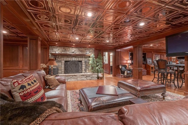 14501 Woolsey Rd, Hampton, GA 30228 - living area with ornate columns, an ornate ceiling, wood finished floors, and a stone fireplace