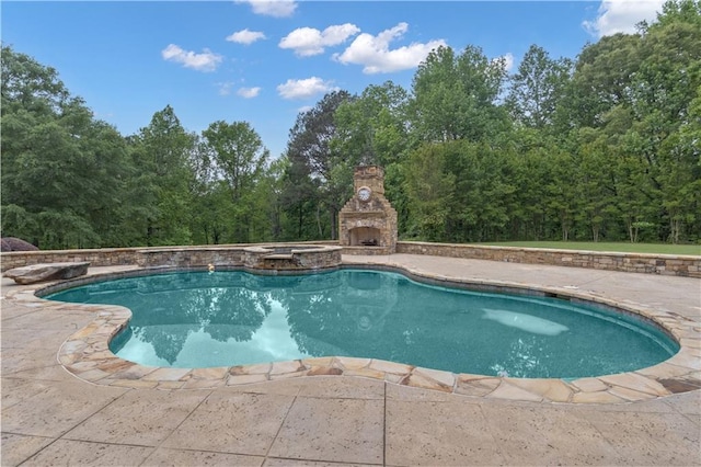 14501 Woolsey Rd, Hampton, GA 30228 - view of swimming pool with an outdoor stone fireplace, a patio area, and a pool with connected hot tub