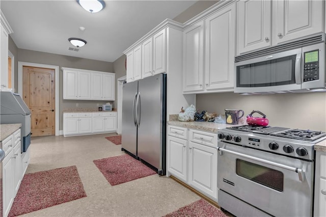 14501 Woolsey Rd, Hampton, GA 30228 - kitchen with stainless steel appliances and white cabinets