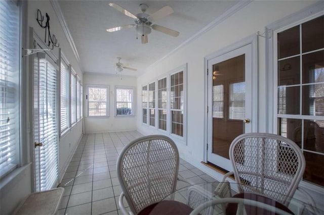 sunroom / solarium featuring ornamental molding, tile patterned floors, and baseboards