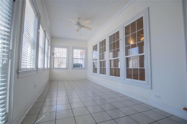 unfurnished sunroom featuring crown molding, tile patterned floors, and baseboards