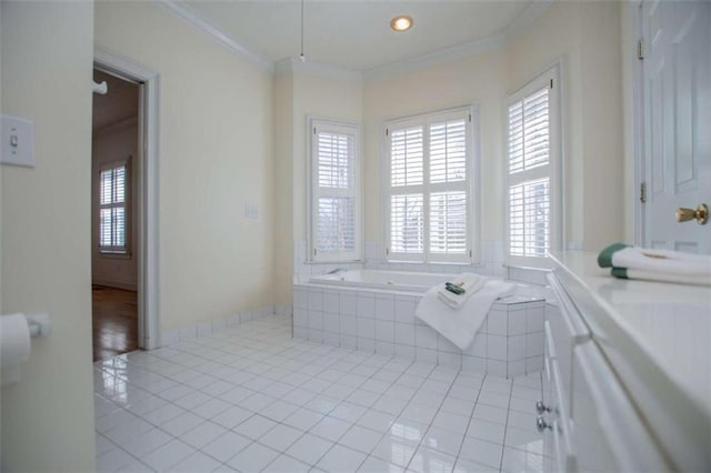 bathroom featuring a bath, tile patterned floors, and ornamental molding