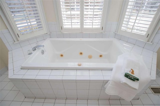 bathroom featuring a jetted tub and tile patterned floors