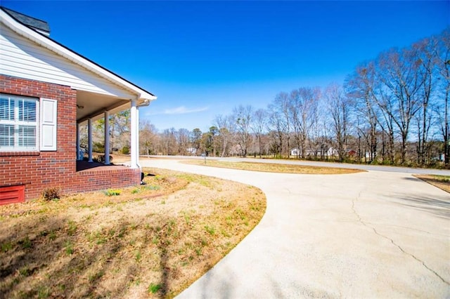 view of yard with curved driveway