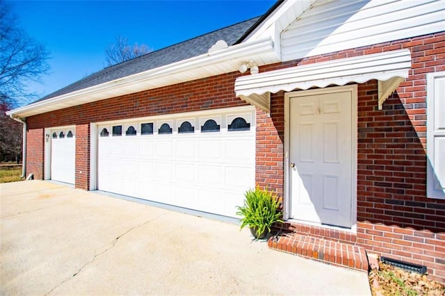 garage with concrete driveway