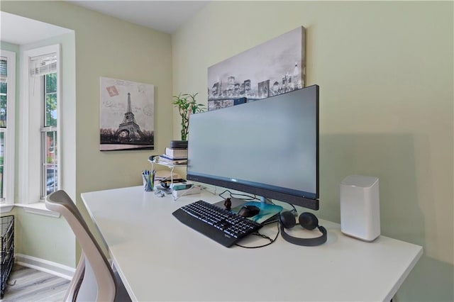 office area with baseboards and wood finished floors