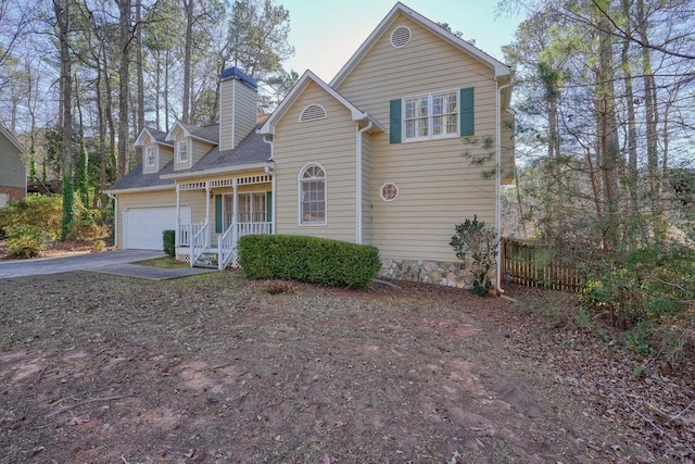 view of front property featuring a porch and a garage