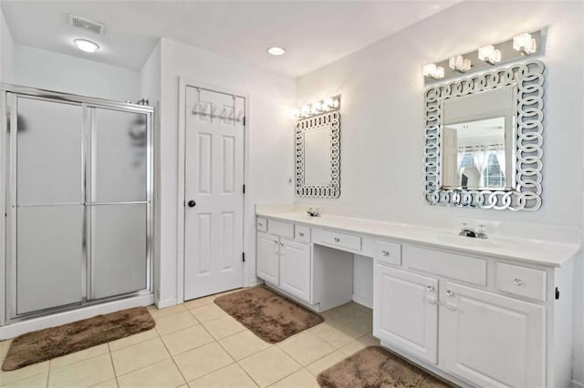 bathroom featuring tile patterned flooring, vanity, and an enclosed shower