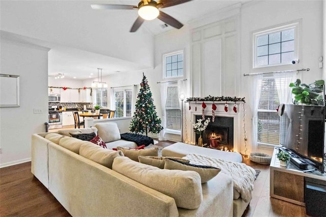 living room featuring ceiling fan, a healthy amount of sunlight, and wood-type flooring