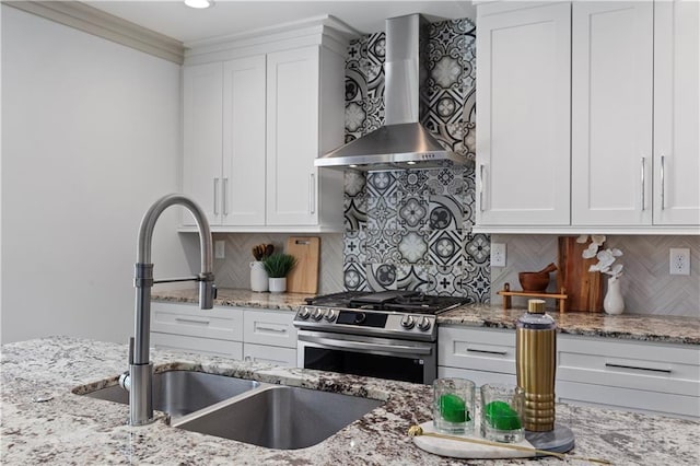 103 Willow Wood Cir SE, Atlanta, GA 30317 - kitchen featuring wall chimney exhaust hood, stainless steel gas stove, a sink, and white cabinets