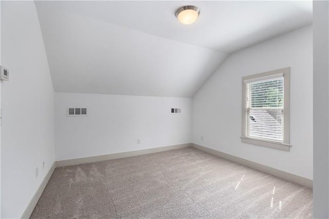 103 Willow Wood Cir SE, Atlanta, GA 30317 - additional living space with light colored carpet, vaulted ceiling, and baseboards
