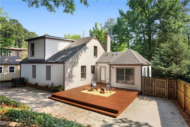 103 Willow Wood Cir SE, Atlanta, GA 30317 - rear view of house featuring a deck, a chimney, a gate, brick siding, and central AC unit